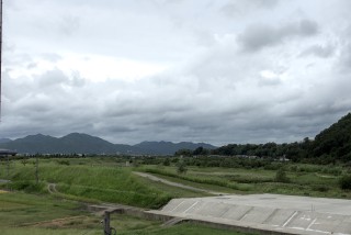 The mountains behind Torokko Kameoka Station in Kyoto, on a cloudy, windy afternoon.