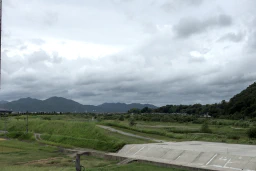 The mountains behind Torokko Kameoka Station in Kyoto, on a cloudy, windy afternoon.